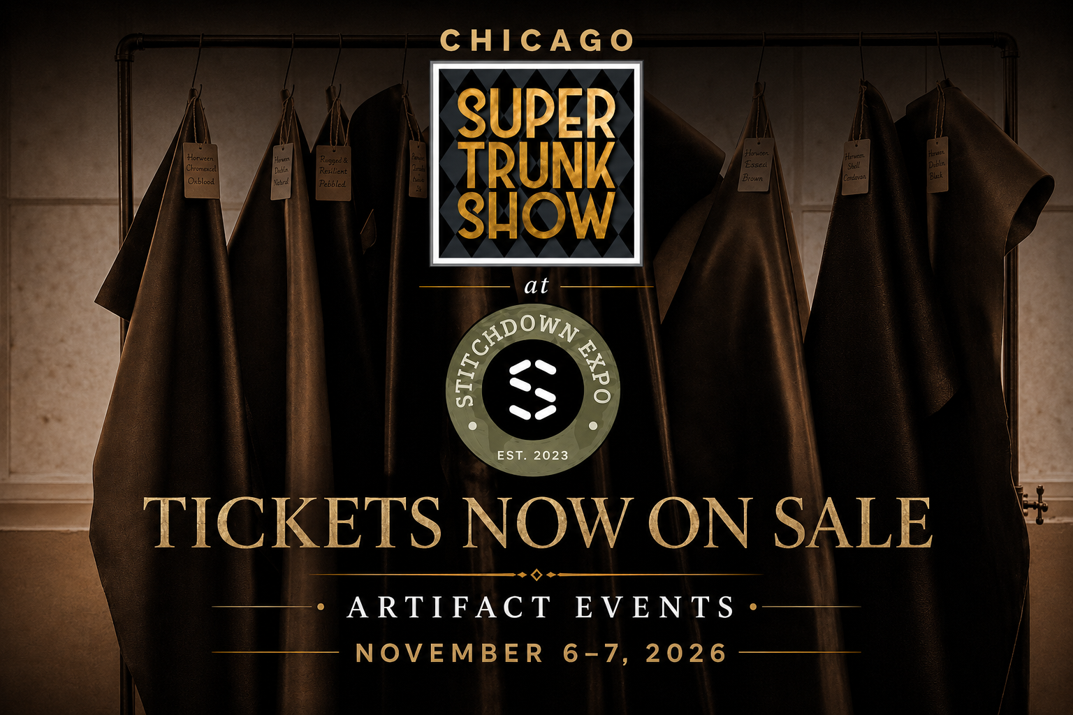 A collection of dark leather pieces hangs from a rack, each labeled with different colors and textures, promoting the Super Trunk Show at Stitchdown Expo.